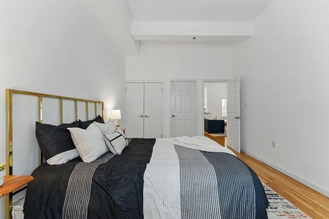 a bedroom with a bed and a painting on the wall