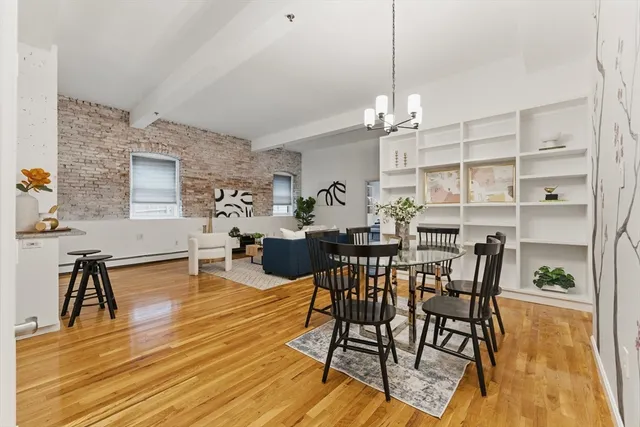 a view of a dining room with furniture and wooden floor