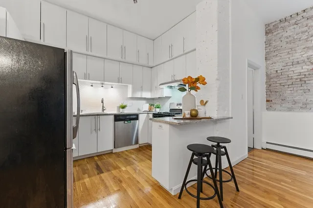 a kitchen with a sink cabinets and window