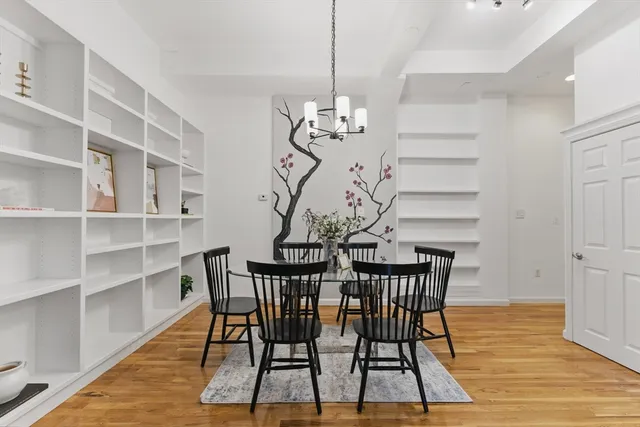 a view of a dining room with furniture wooden floor and chandelier