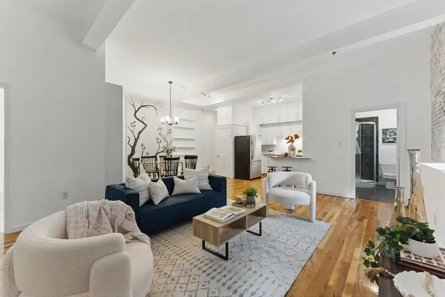 a living room with furniture and a chandelier