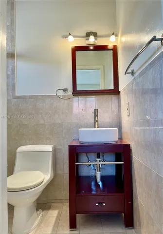 a bathroom with a sink a toilet and a mirror