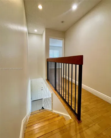 a view of a patio with table and chairs under an umbrella