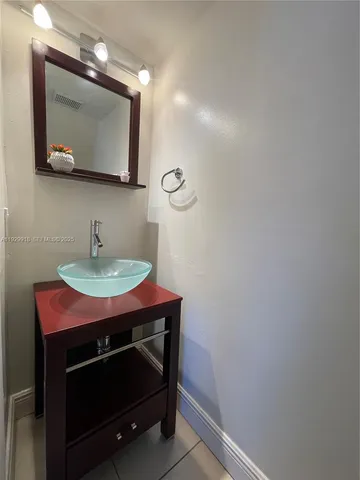 a bathroom with a sink a mirror and vanity