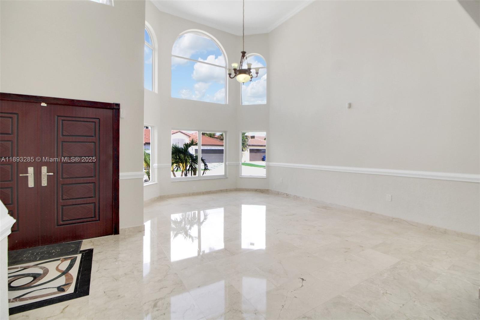 8416 Northwest 201st Street Hialeah, FL 33015 - Photo 14 of 40 Very large floor to ceiling impact windows. Front doors are imported and have multi-point locking pin system.