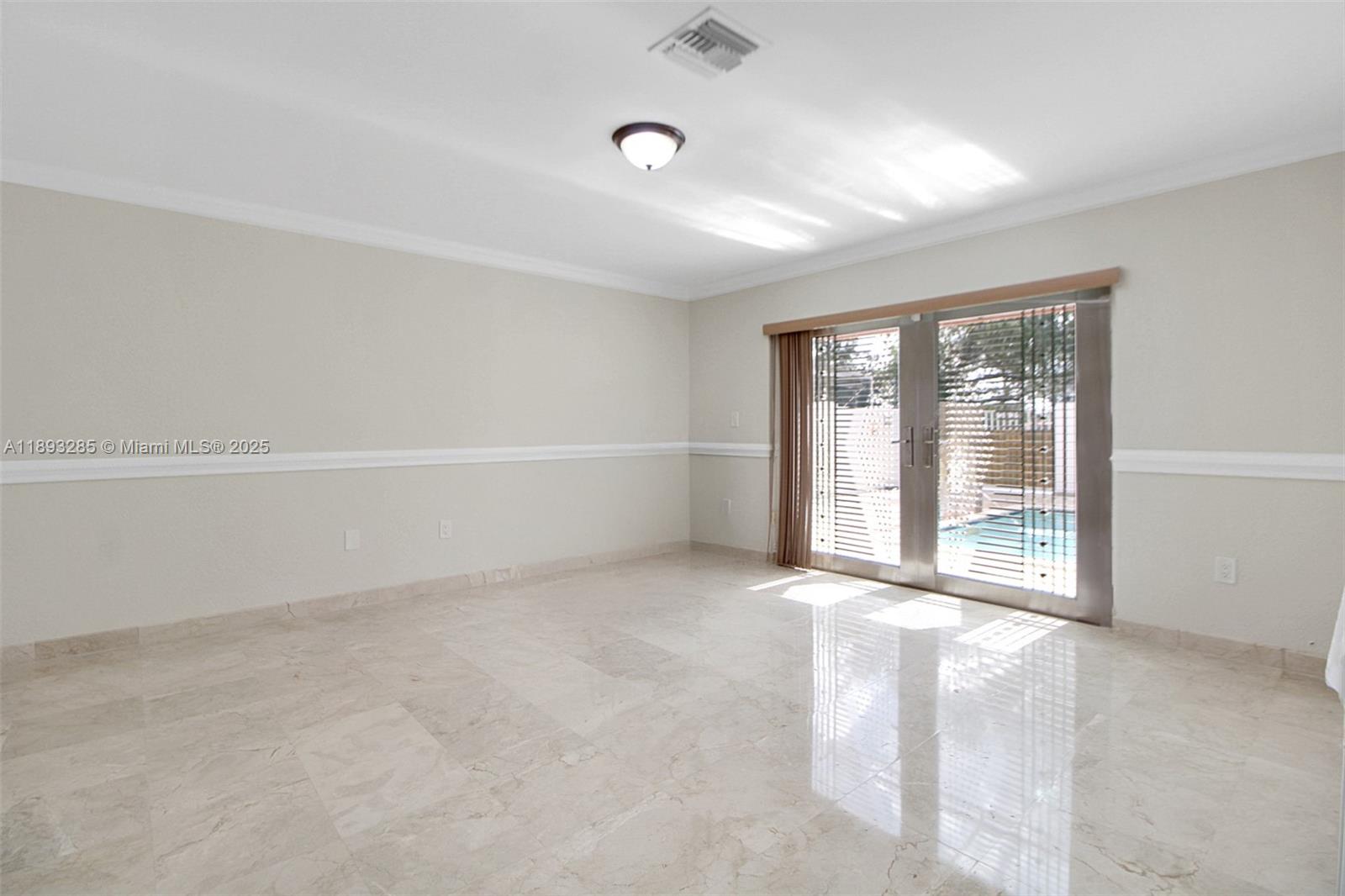 8416 Northwest 201st Street Hialeah, FL 33015 - Photo 18 of 40 The primary bedroom is the only bedroom located on the first floor. The doors are security doors imported from Mexico. They have intricate grills between the glass panes.