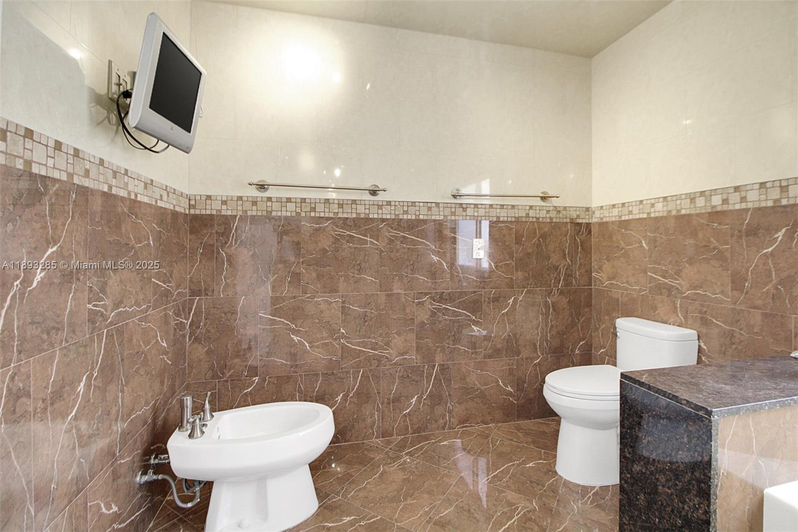 8416 Northwest 201st Street Hialeah, FL 33015 - Photo 22 of 40 This bathroom has a bidet and access to security camera feed.