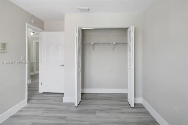 a view of an empty room with a staircase