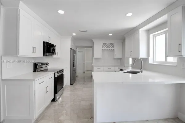 a kitchen with a sink stove and refrigerator