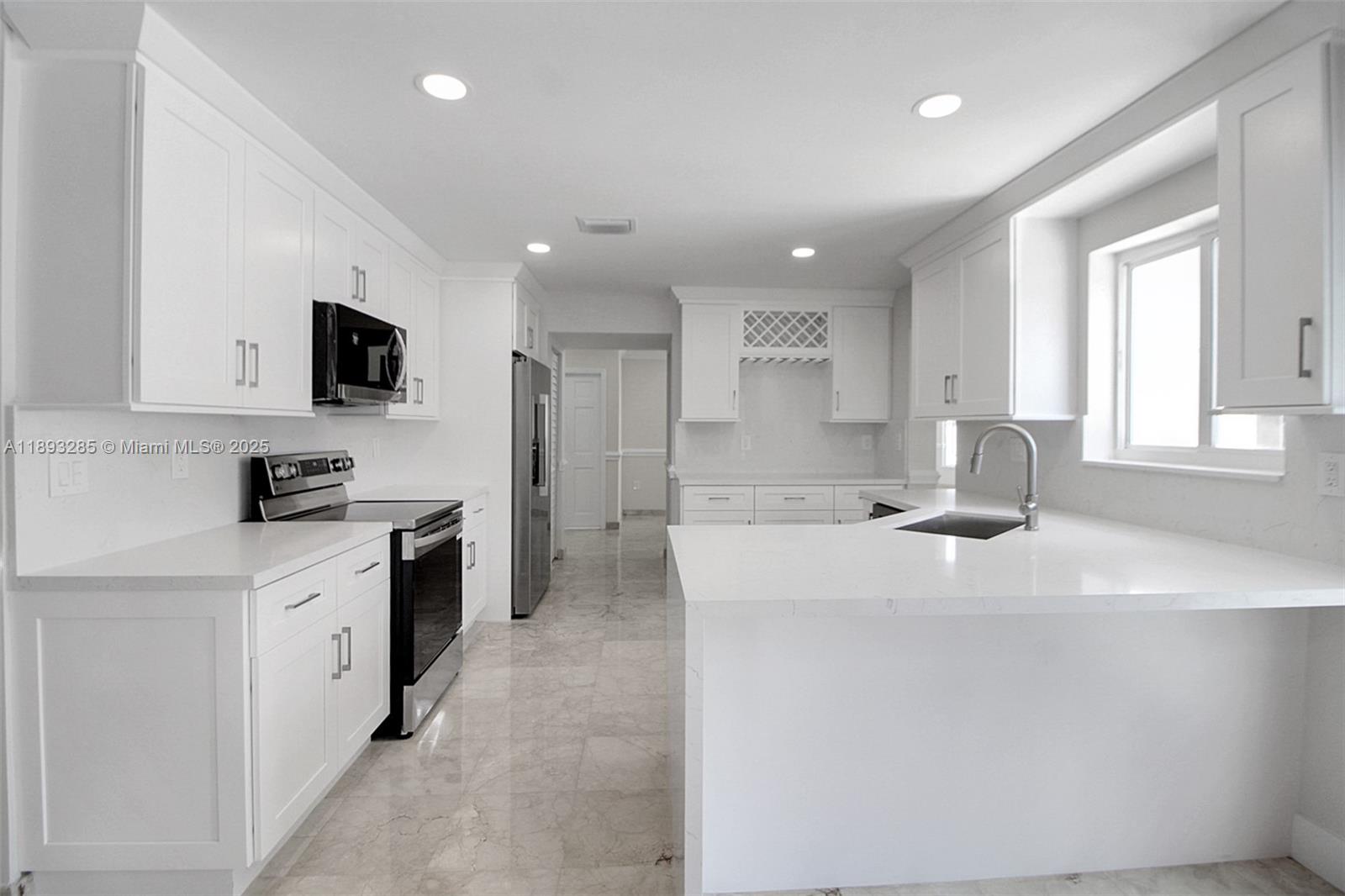 8416 Northwest 201st Street Hialeah, FL 33015 - Photo 3 of 40 Brand new kitchen with waterfall countertop, deep sink and all new appliances.