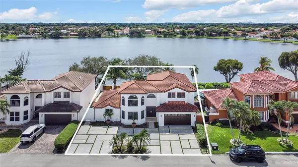 an aerial view of a house with a yard