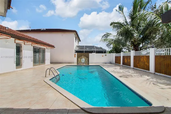 a view of a backyard with pool