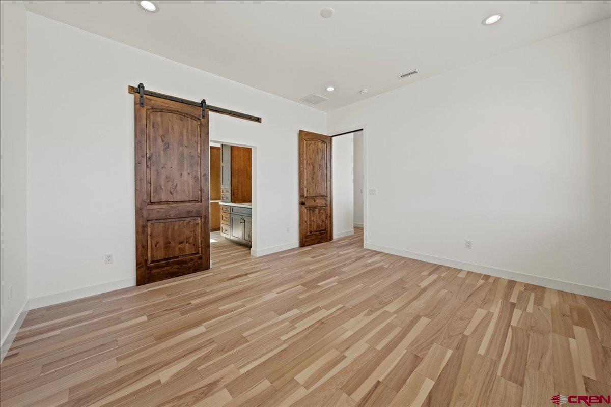 14447 5950 Road Montrose, CO 81403 - Photo 15 of 45 a view of an empty room with wooden floor and a window