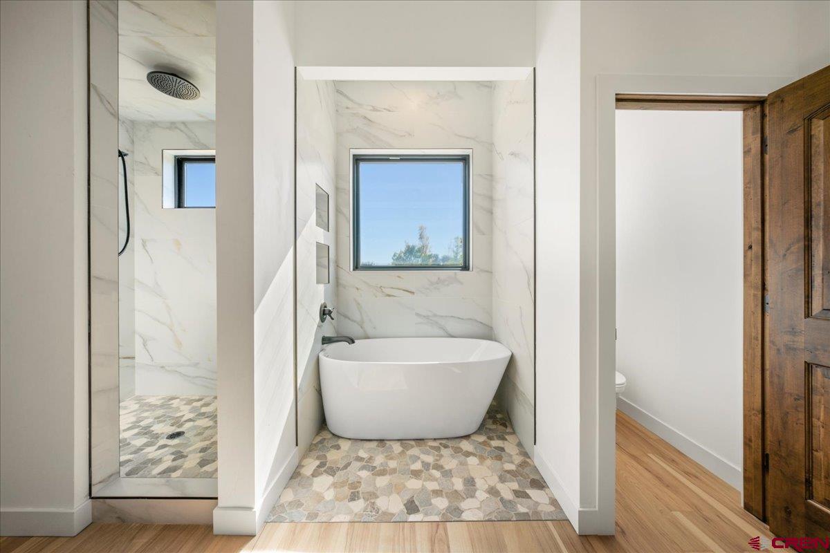 14447 5950 Road Montrose, CO 81403 - Photo 18 of 45 a bathroom with a bathtub and shower