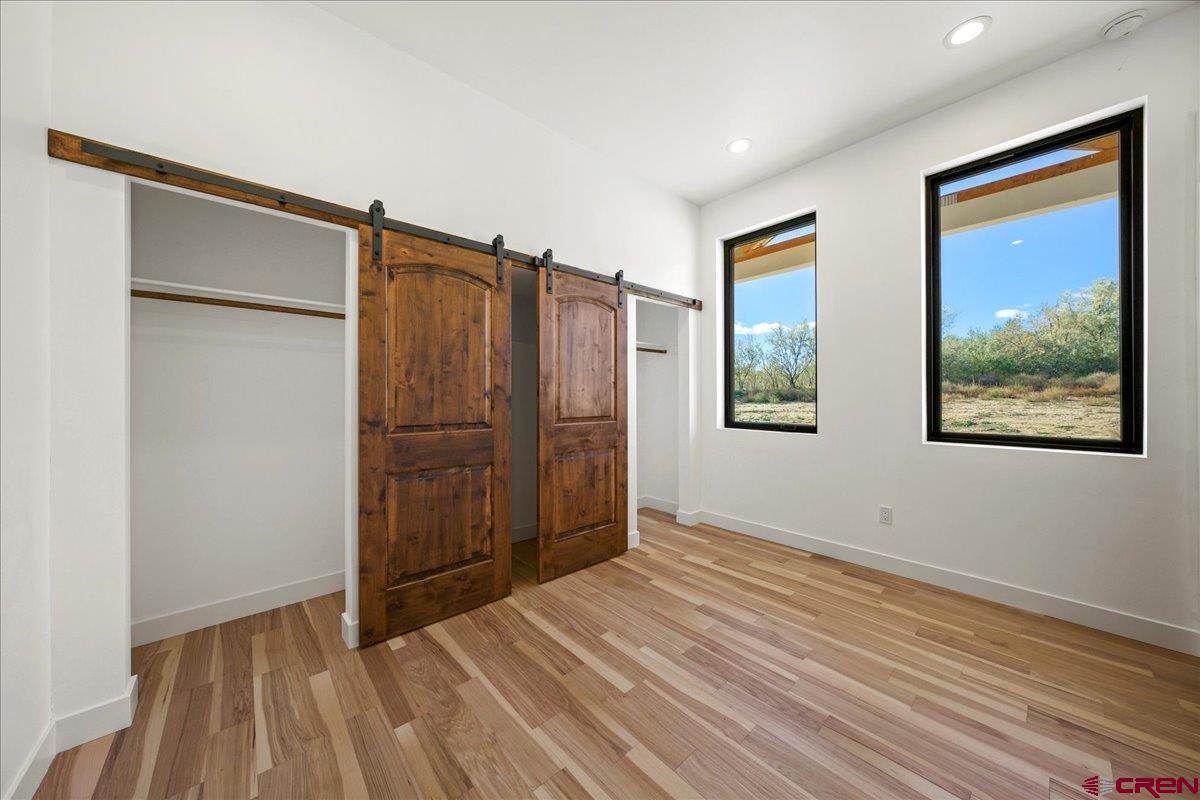 14447 5950 Road Montrose, CO 81403 - Photo 23 of 45 a view of a room with wooden floor closet and windows