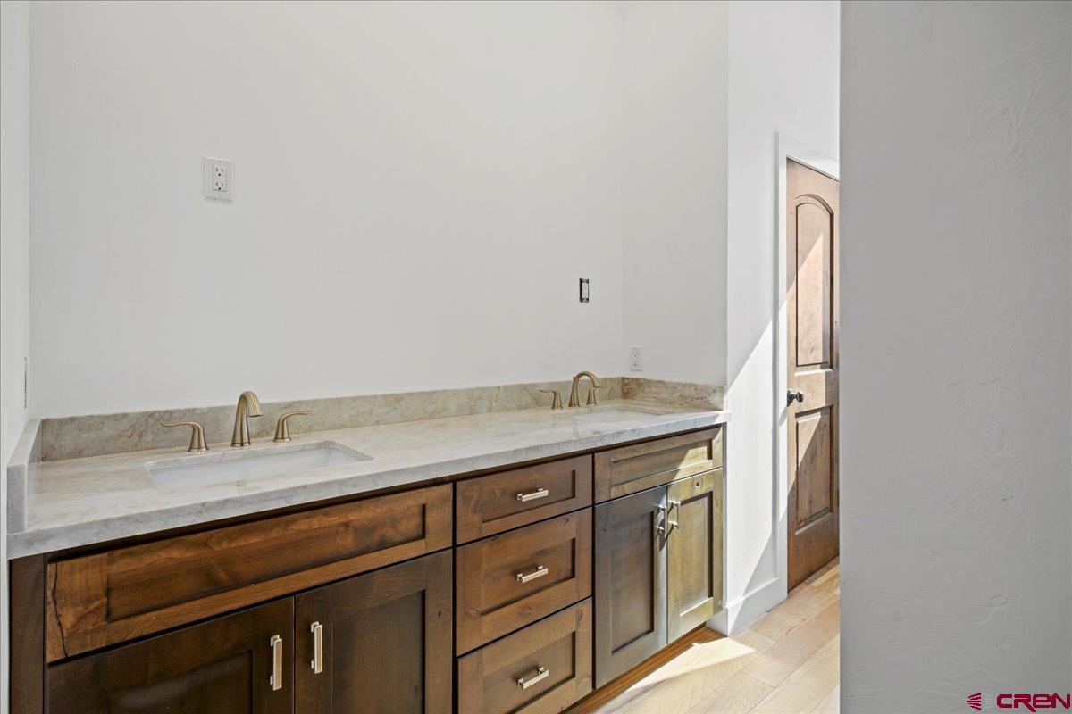 14447 5950 Road Montrose, CO 81403 - Photo 27 of 45 a bathroom with a granite countertop sink and a mirror