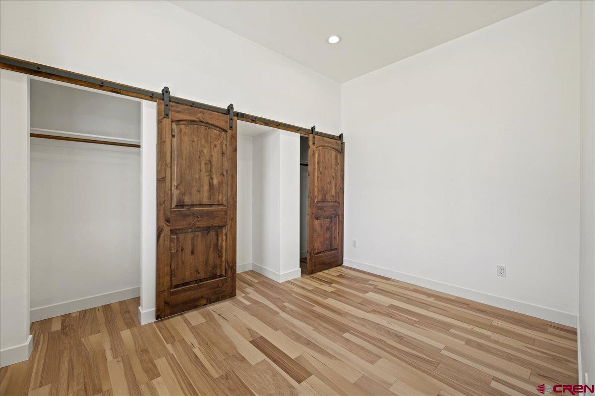 14447 5950 Road Montrose, CO 81403 - Photo 29 of 45 a view of empty room with wooden floor and cabinets