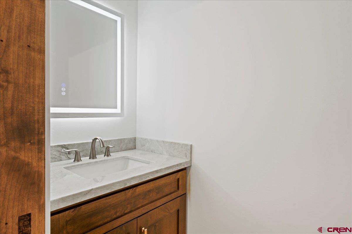 14447 5950 Road Montrose, CO 81403 - Photo 30 of 45 a bathroom with a sink and a mirror