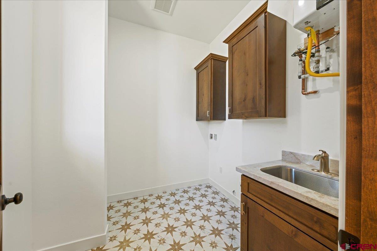 14447 5950 Road Montrose, CO 81403 - Photo 33 of 45 a bathroom with a sink and a mirror
