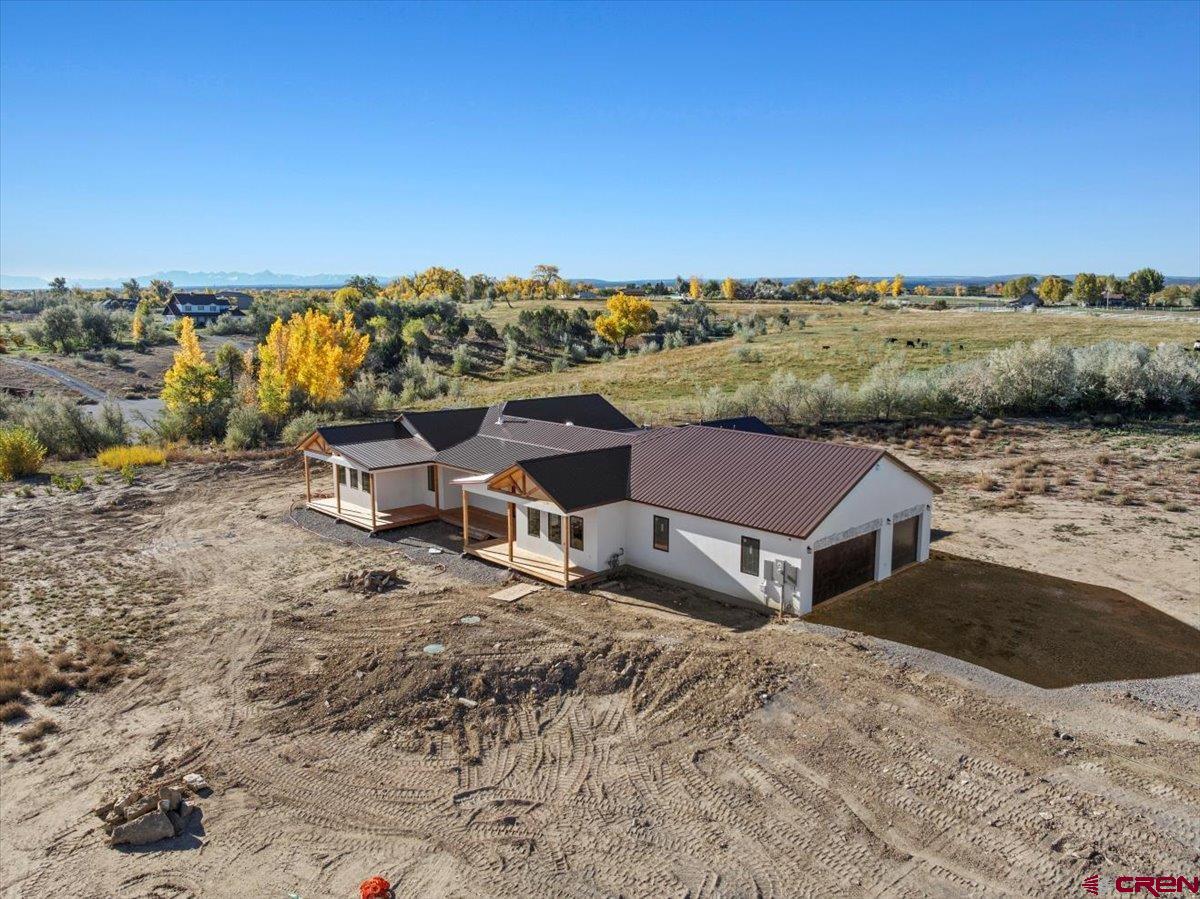 14447 5950 Road Montrose, CO 81403 - Photo 41 of 45 a view of a house with a yard and lake view