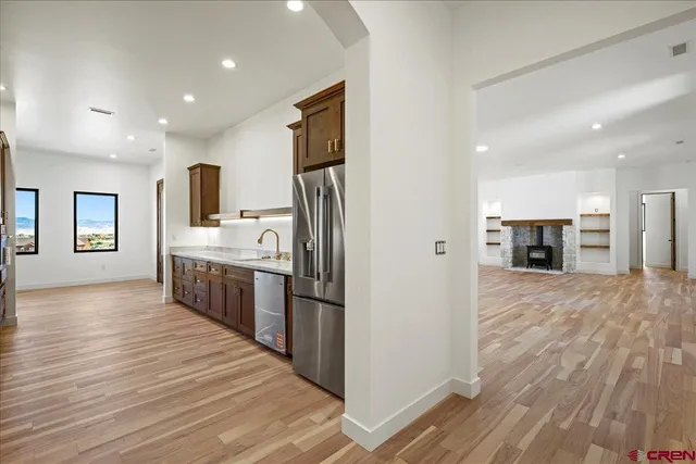 a large kitchen with kitchen island a sink stainless steel appliances and cabinets