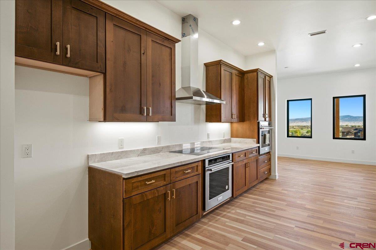 14447 5950 Road Montrose, CO 81403 - Photo 8 of 45 a kitchen with stainless steel appliances granite countertop a sink stove and refrigerator