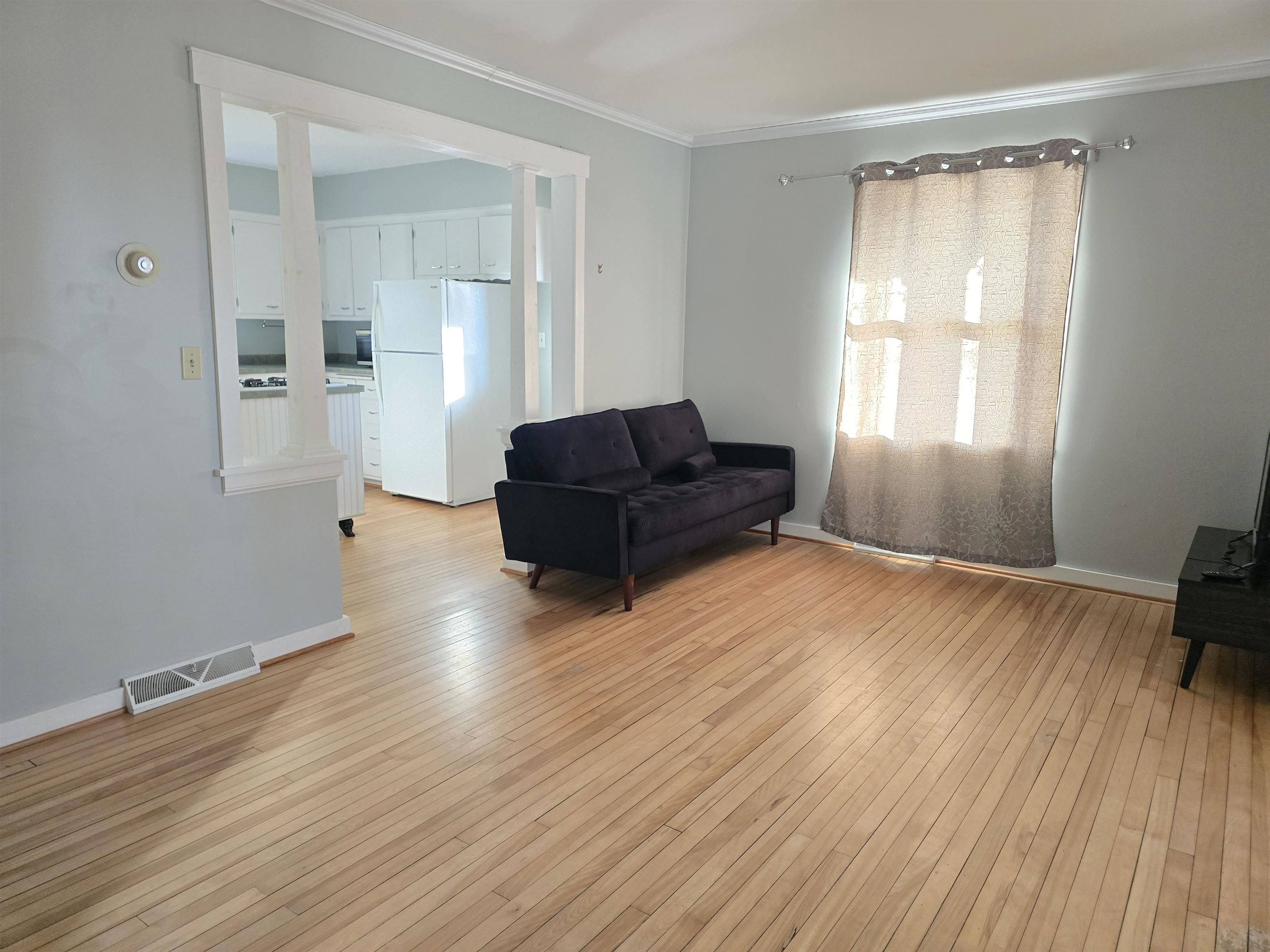 321 Rice Avenue Bayfield, WI 54814 - Photo 21 of 30 Living area with ornamental molding and light original hardwood flooring