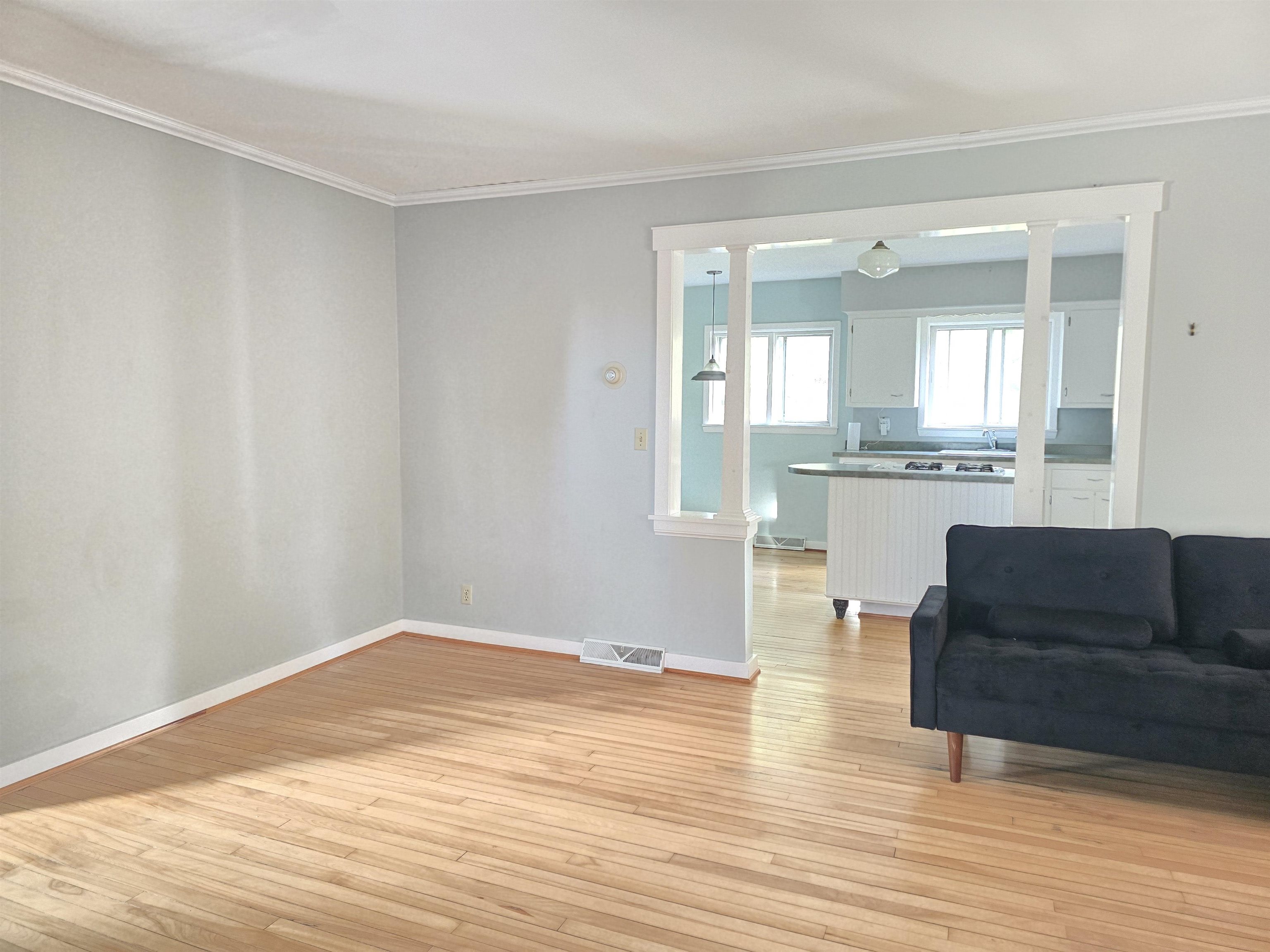 321 Rice Avenue Bayfield, WI 54814 - Photo 22 of 30 Living room featuring light hardwood floors, crown molding, and sink