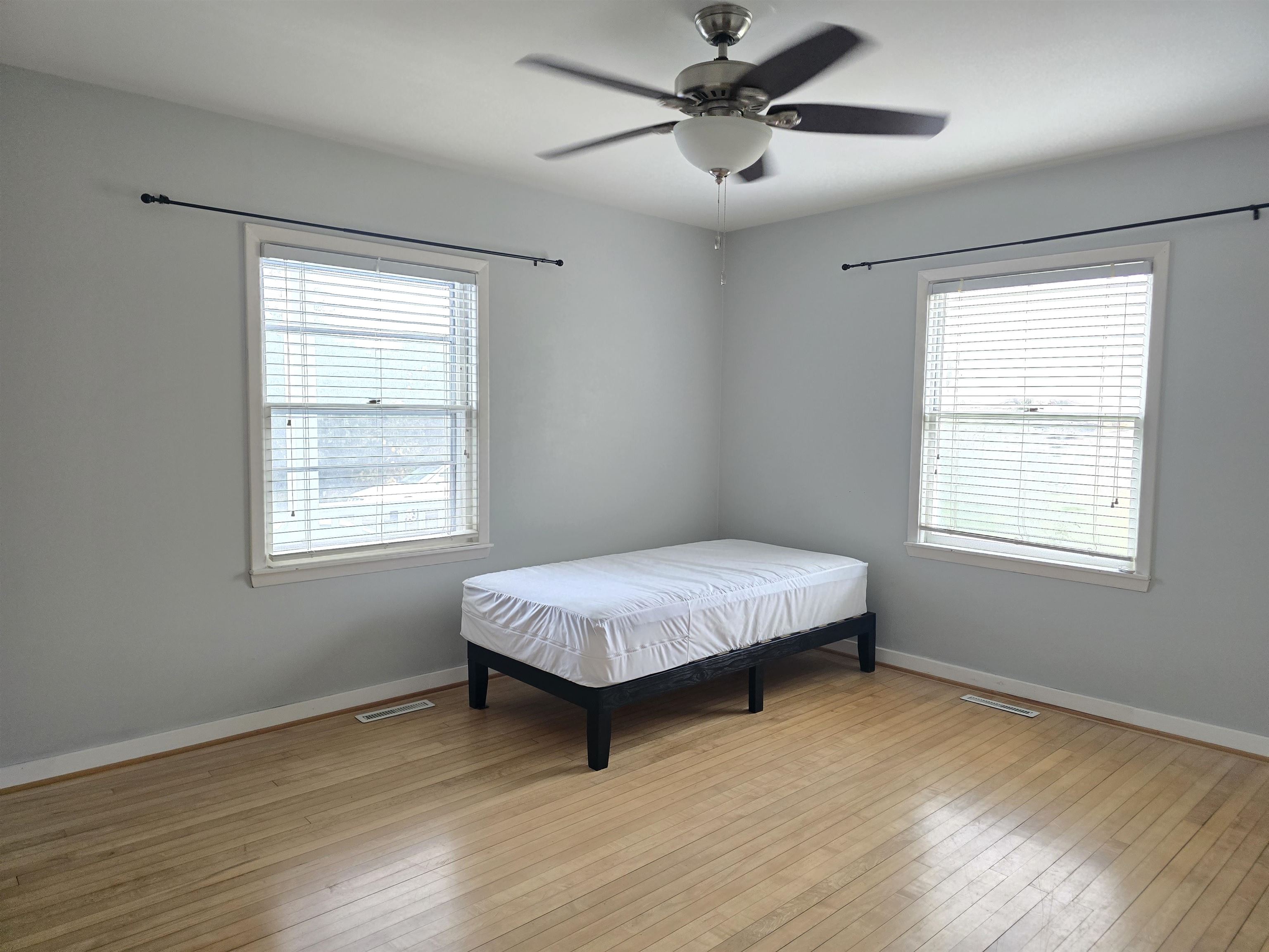 321 Rice Avenue Bayfield, WI 54814 - Photo 23 of 30 Bedroom featuring original hardwood floors and ceiling fan