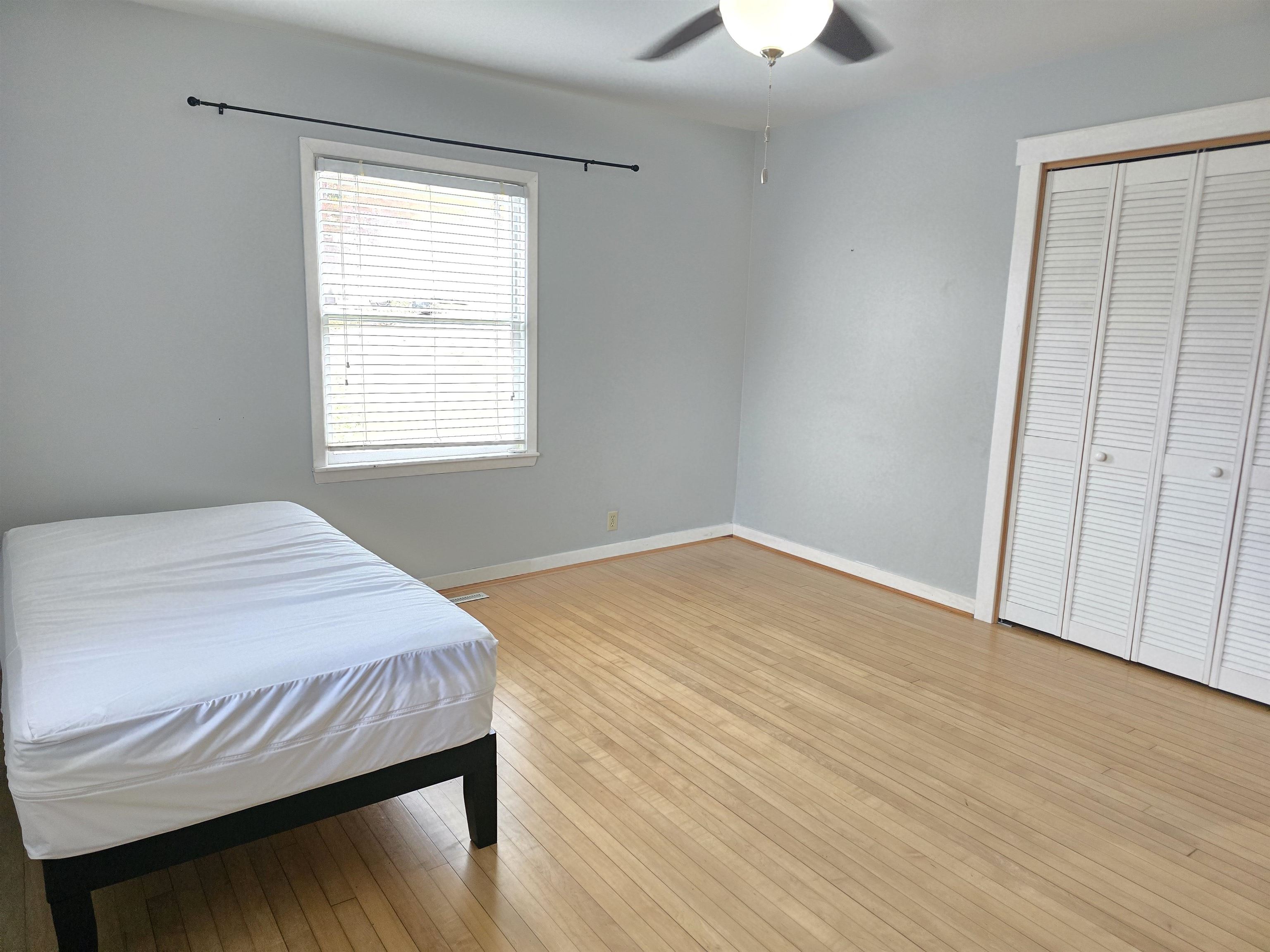 321 Rice Avenue Bayfield, WI 54814 - Photo 24 of 30 Bedroom with a closet, light hardwood floors, and ceiling fan