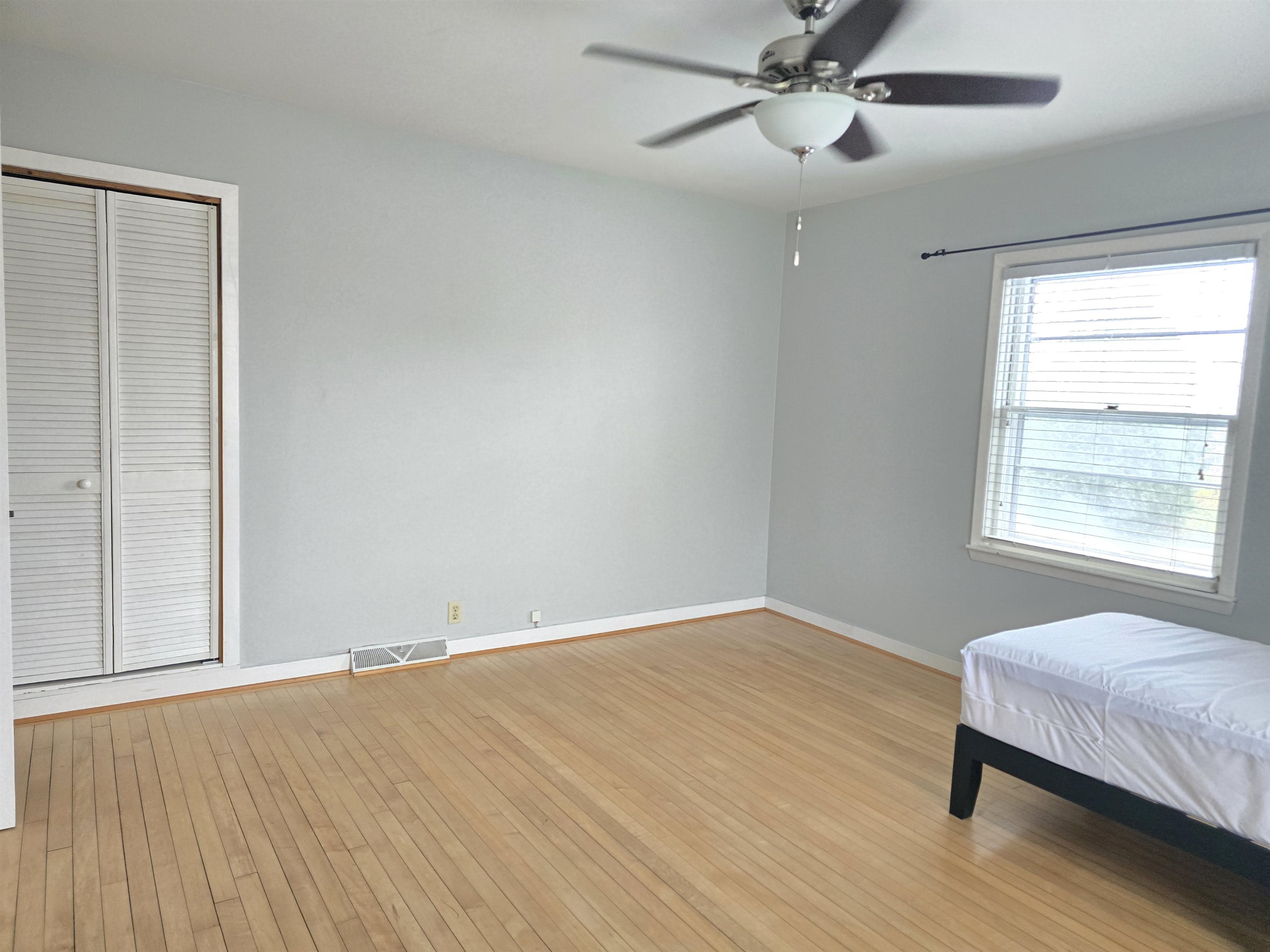 321 Rice Avenue Bayfield, WI 54814 - Photo 25 of 30 Bedroom with light hardwood flooring, a closet, and ceiling fan