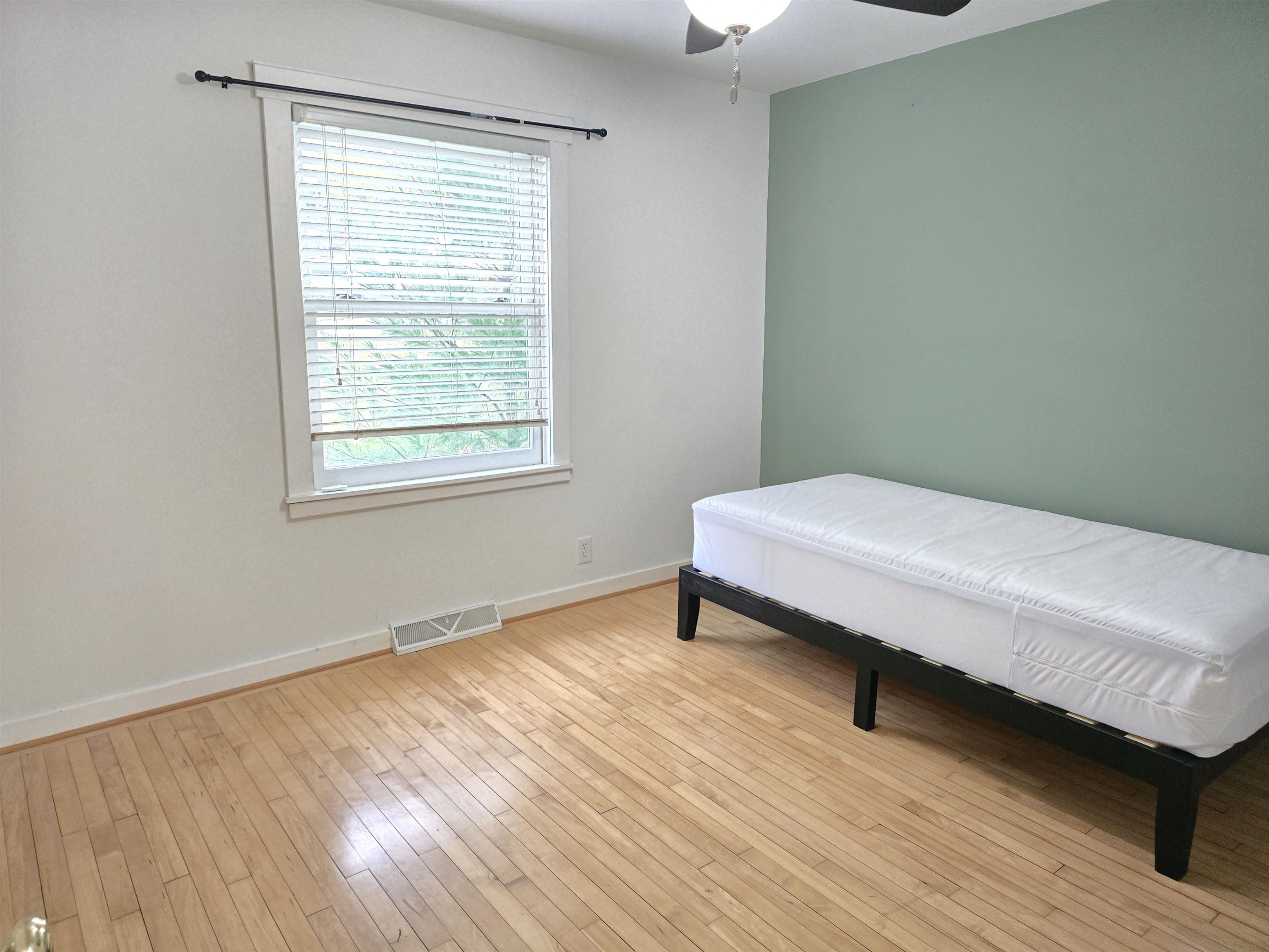 321 Rice Avenue Bayfield, WI 54814 - Photo 28 of 30 Bedroom with light hardwood floors and ceiling fan