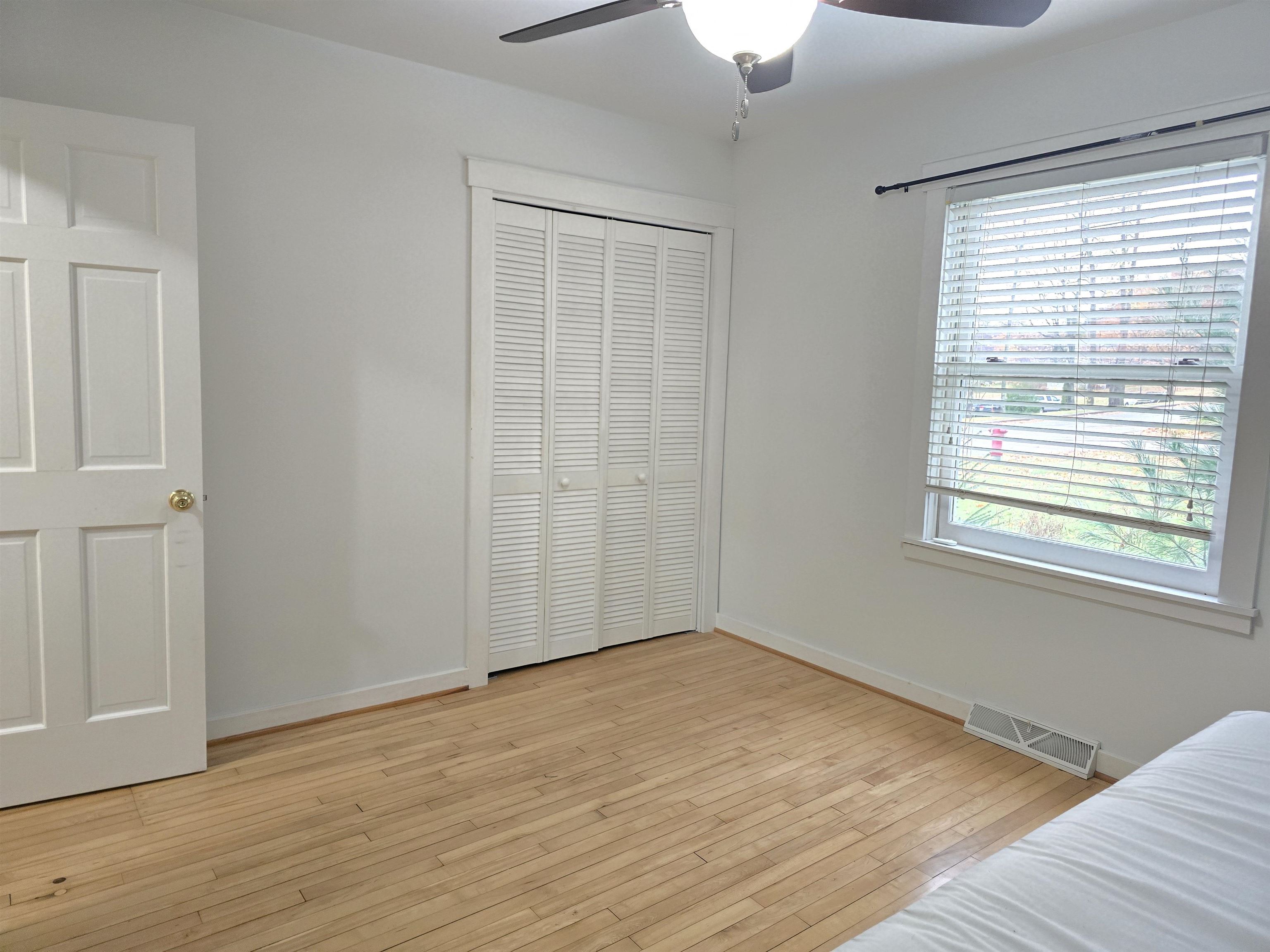 321 Rice Avenue Bayfield, WI 54814 - Photo 29 of 30 Bedroom featuring a closet, light hardwood floors, and ceiling fan