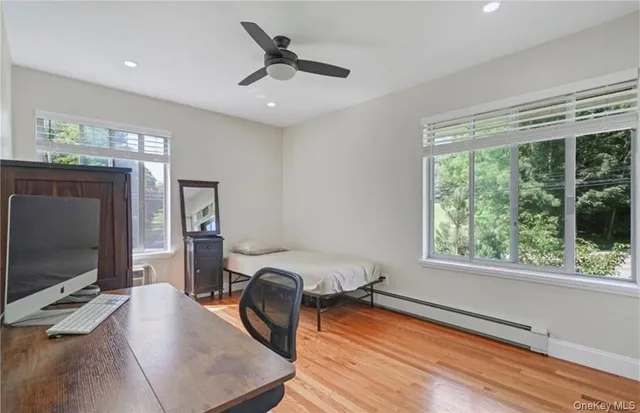 a bedroom with furniture and a flat screen tv