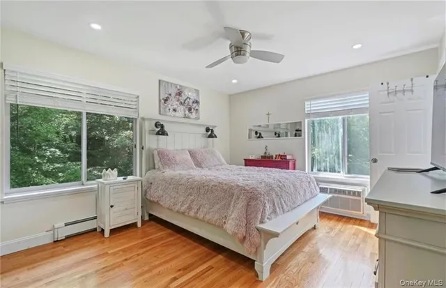 a bedroom with a large bed and a large window