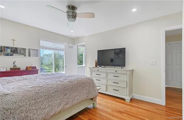 a bedroom with a bed and flat screen tv