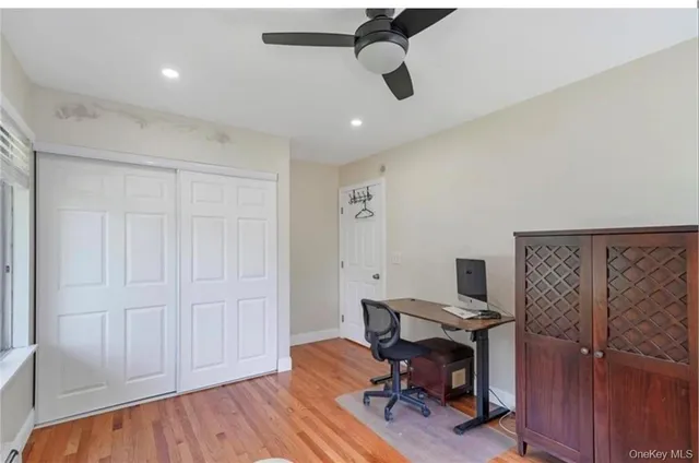 a view of a workspace with furniture and wooden floor