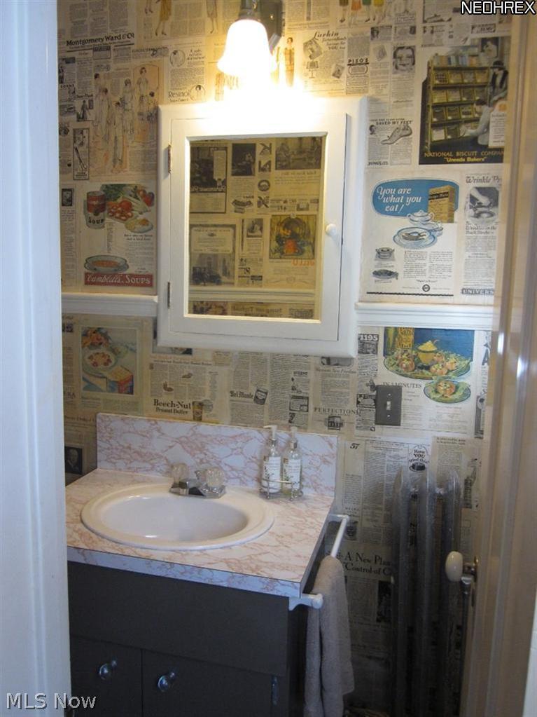 3344 Elsmere Road Cleveland, OH 44120 - Photo 16 of 25 Half bath has a wall covered with magazine articles from the era of the house (1923-1925)