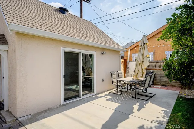 a view of a patio with table and chairs and potted plants