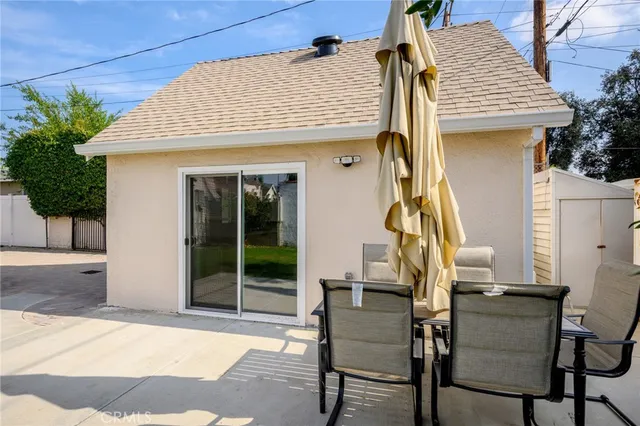 a view of a patio with table and chairs with wooden floor and fence