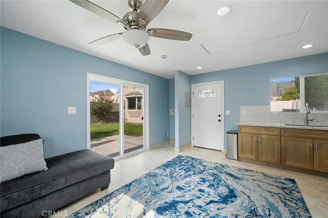 a spacious bedroom with a bed and a dresser next to a window