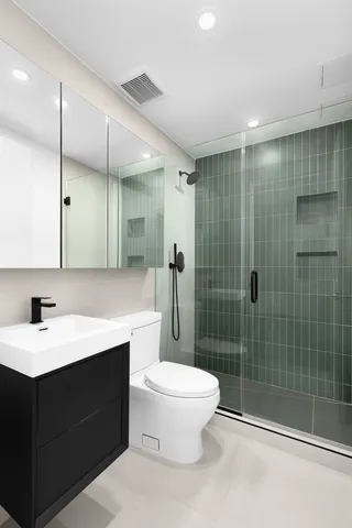 a view of an empty room with wooden floor and windows