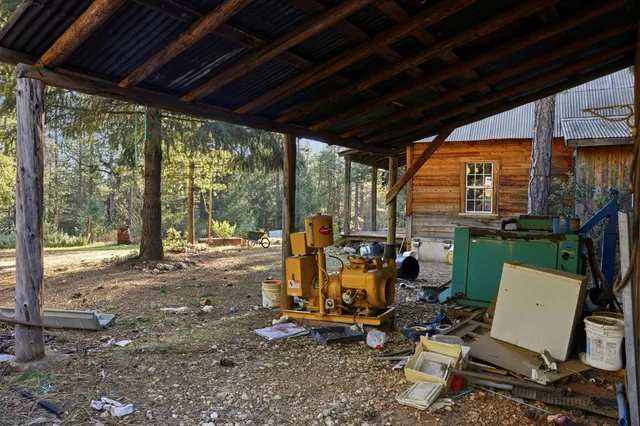 a view of a patio with chairs and floor to ceiling window