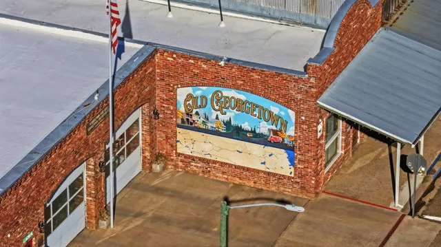 a view of a yard with wooden fence