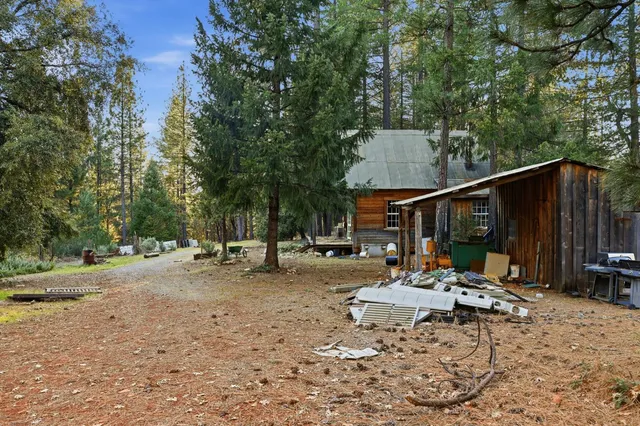 a backyard of a house with table and chairs