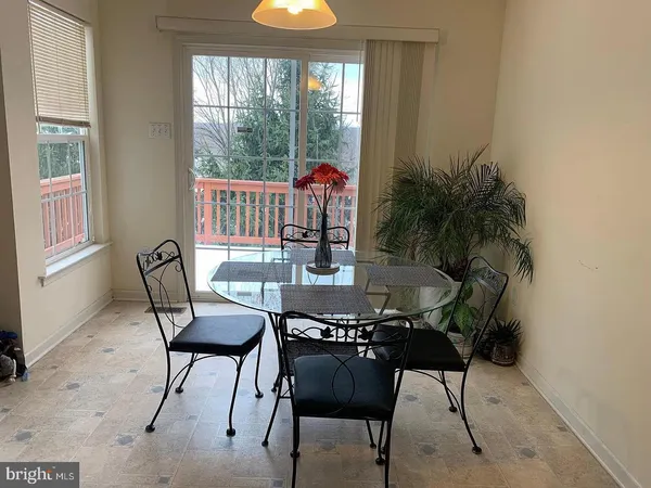 a living room with furniture and a lamp