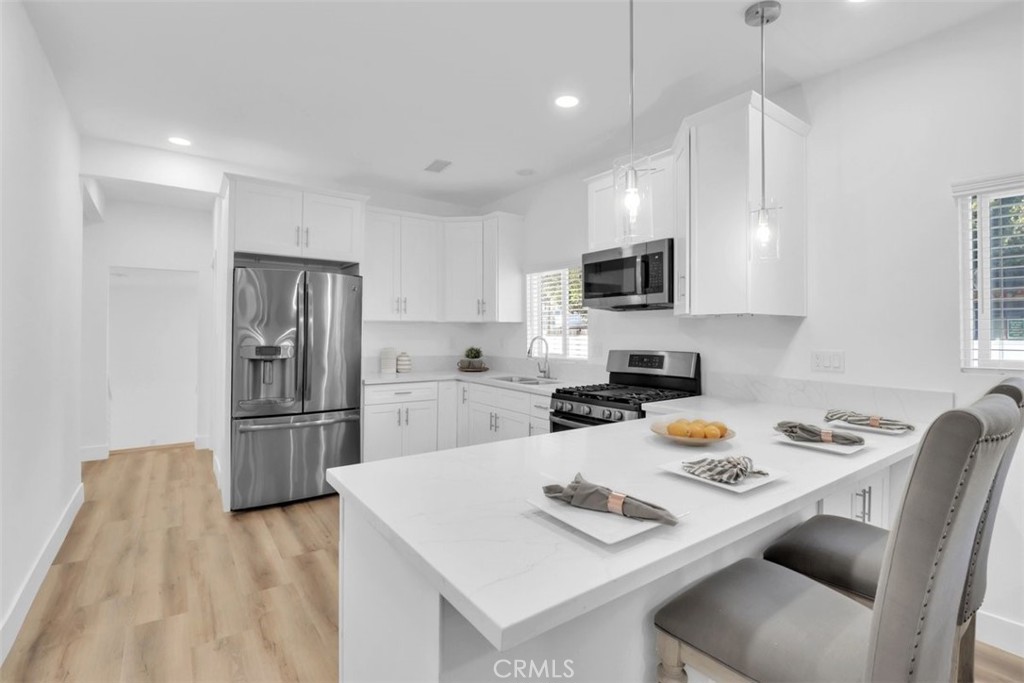 2697 Merced Street Los Angeles, CA 90065 - Photo 3 of 10 a kitchen with a refrigerator a stove a sink and a stove