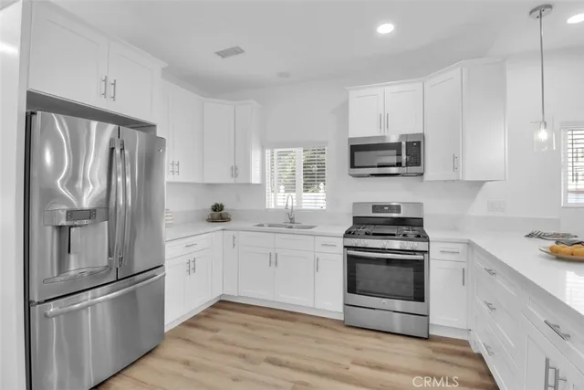 a kitchen with stainless steel appliances a refrigerator stove and microwave