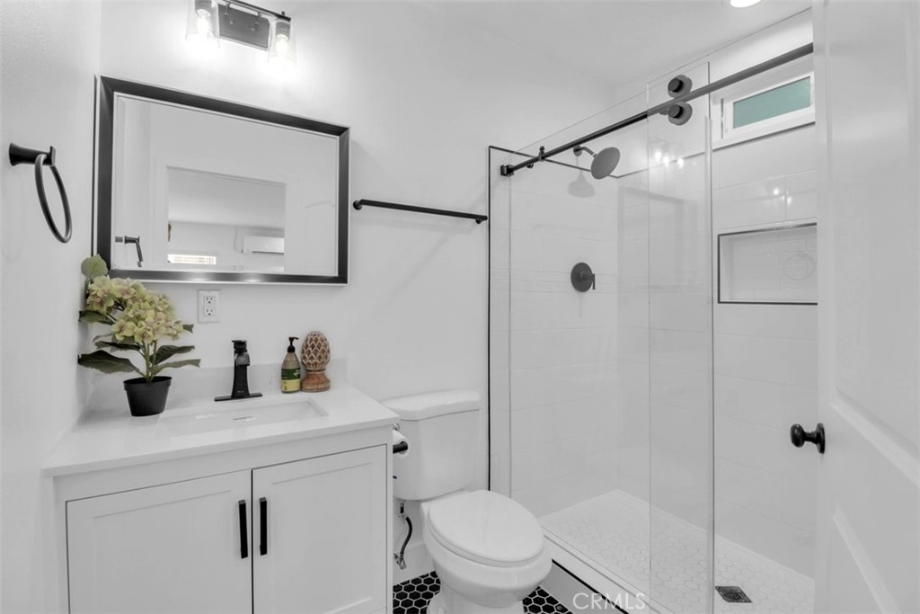 2697 Merced Street Los Angeles, CA 90065 - Photo 7 of 10 a bathroom with a shower sink vanity mirror and toilet