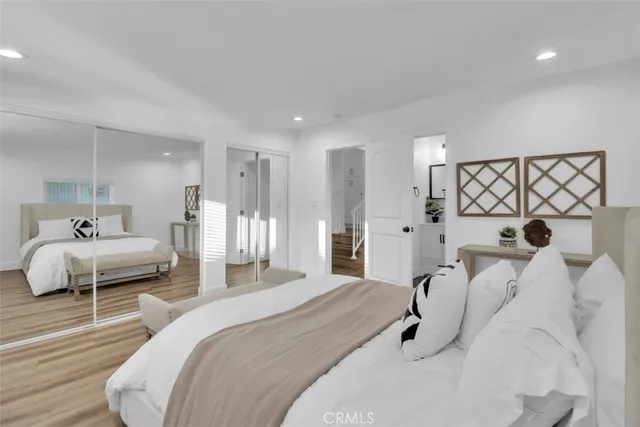 a spacious bedroom with a bed and a couch